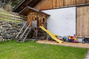 a playground with a slide and a play house at Stoffnerhof Apt Sonnenblume in Tesido