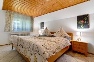 a bedroom with a bed and a wooden ceiling at Schwarzwald Buchenhof in Zell am Harmersbach