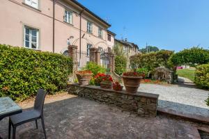 a house with a table and chairs and some plants at Villa Chelucci - Gualdo in Massarosa