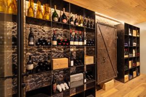a wall filled with lots of bottles of wine at K Lodge View in Valdaora