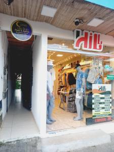 a store front of a store with two men in the window at Flat Lua Nova - Pituba I coração da vila e caminho praias in Itacaré