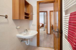 a bathroom with a sink and a door to a hallway at Appartamento Vacanze Matteo in Livigno +19 photos
