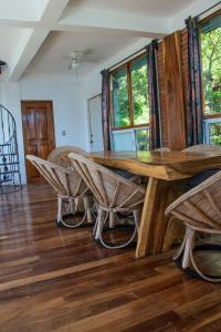a dining room with a wooden table and chairs at casa wow in Puerto Ángel +32 photos