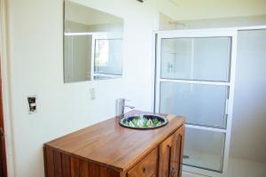 a bathroom with a sink and a glass shower at casa wow in Puerto Ángel