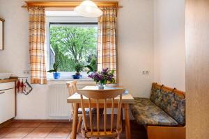 a kitchen with a table and a couch and a window at Monteurwohnung in Schwanewede