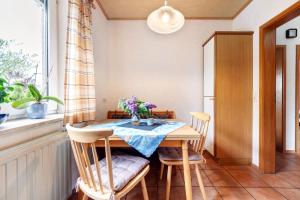 a dining room with a table with flowers on it at Monteurwohnung in Schwanewede +15 photos