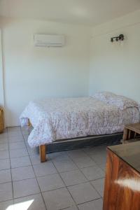 a bedroom with a bed in a room at casa wow in Puerto Ángel