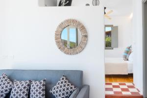 a living room with a couch and a mirror at Luna Rossa Milos - Chili Moon in Provatas +21 photos
