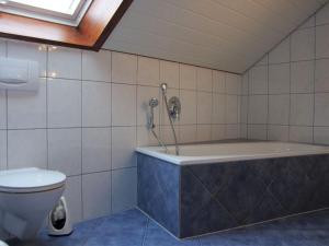 a bathroom with a tub and a toilet at Ferienwohnung Tea in Eriskirch +58 photos