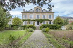 a large house with a pathway in front of it at Suite Oiseau du Paradis in Fontenay-le-Comte