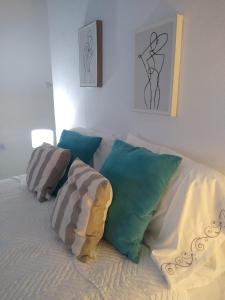a bed with pillows on it in a bedroom at O Connor Santiago del Estero in Santiago del Estero