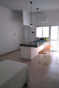 a kitchen with a counter and a chair in a room at O Connor Santiago del Estero in Santiago del Estero