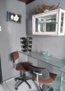 a glass desk with a chair and a window at Loft central in Pelotas