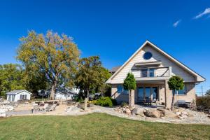 a house with a patio and a yard at Waterfront Luxury Family Retreat in Sandusky
