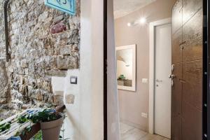 a hallway with a stone wall and a door at Grazioso open space in Sanremo +14 photos