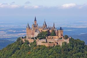 a castle on top of a hill with trees at Apartment Alb Glück 2 in Hechingen