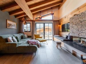 a living room with a couch and a fireplace at Wagrainer TauernLodge 42D in Wagrain