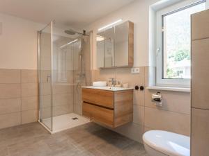 a bathroom with a shower and a sink and a toilet at Villa Felding Top 4 in Bad Hofgastein +25 photos