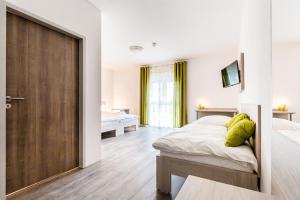 a bedroom with a bed and a sliding door at Hotel ANNA - Düsseldorf - Hilden in Hilden