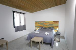 a bedroom with a bed with two towels on it at Fiumara Val Di Noto Country Rooms in Noto
