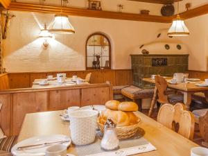 a dining room with a table with bread on it at Pension Blaiken XL in Scheffau am Wilden Kaiser +30 photos
