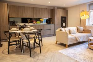 een keuken en woonkamer met een tafel en een bank bij 10 Park Square - Luxury Serviced Apartments in Central Station