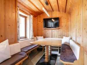 a dining room with a table and a tv at Pension Schreder in Kirchberg in Tirol