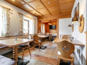 a dining room with wooden tables and chairs at Pension Schreder in Kirchberg in Tirol