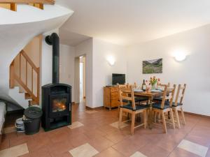 a living room with a fireplace and a table and chairs at Haus Oliver 1 in Längenfeld
