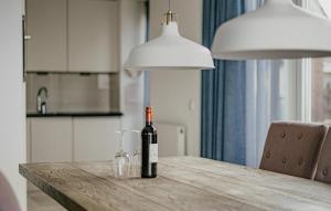 a bottle of wine sitting on a table in a kitchen at Lobster in Egmond aan Zee