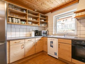 a kitchen with wooden cabinets and a window at Haus Joachim in Längenfeld +44 photos
