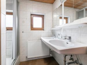 a white bathroom with a sink and a window at Haus Joachim in Längenfeld
