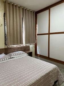 a bedroom with a bed and a large window at Apto lindo em Alter do chão in Alter do Chao +30 photos