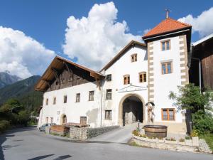 a large white building with a wooden roof at Schloss Sissi in Stuben