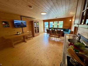 a living room with a kitchen and a dining room at Schwarzmann in Mellau