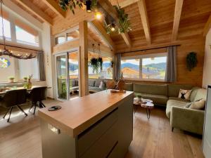 a kitchen and living room in a house at Grebenzen Lodge Edelweiss in Sankt Lambrecht