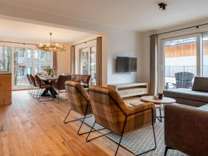 a living room with a couch and chairs and a table at Mountain Chalet Dahoam in Sankt Lorenzen ob Murau
