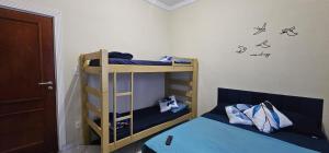 two bunk beds in a room with words on the wall at Pousada House Beach 2 - BRASIL - Aviação in Praia Grande +47 photos