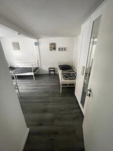 a hallway with a room with two beds and a door at 8 Personen Appartment Bad Rappenau in Bad Rappenau