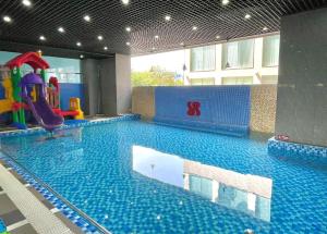 a large swimming pool with a slide in a building at 1103 - Tháp Tam Thắng Vũng Tàu in Vung Tau