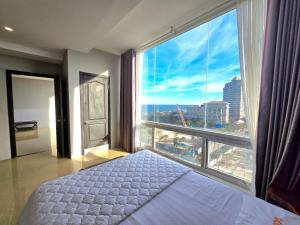a bedroom with a bed and a large window at 1103 - Tháp Tam Thắng Vũng Tàu in Vung Tau +40 photos
