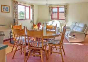 a dining room with a table and chairs at Avalon Cottages in Llangynin +9 photos