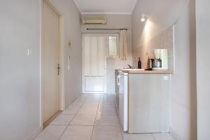 a kitchen with a refrigerator and a tile floor at Dolphin Studio Sea View 11 in Keri +12 photos