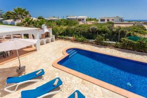 a villa with a swimming pool and a patio at Racó Blau in Cap d'en Font