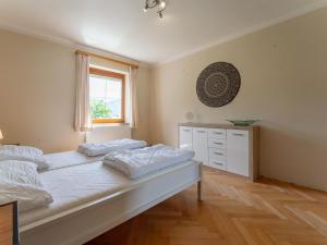 a bedroom with a large bed and a window at Jukbichl 1 in Laas