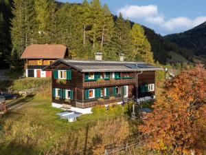 a wooden house in the middle of a forest at Carmaliva in Innerkrems