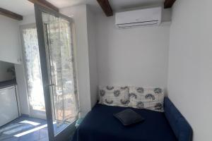 a bedroom with a blue bed and a window at Apartments by the sea Novigrad - 24877 in Novigrad Istria