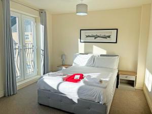 a hotel room with a bed with a red shirt on it at Solara Breeze in Reighton