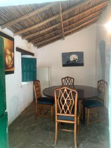a dining room with a wooden table and chairs at Casa Victoria in Piedecuesta