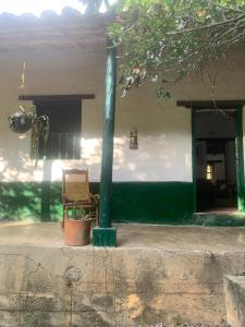 a chair and a pole in front of a house at Casa Victoria in Piedecuesta +5 photos